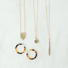 Various Dear Mushka gold necklaces and Shell earrings