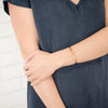 Woman wearing Vision gold cuff bracelet