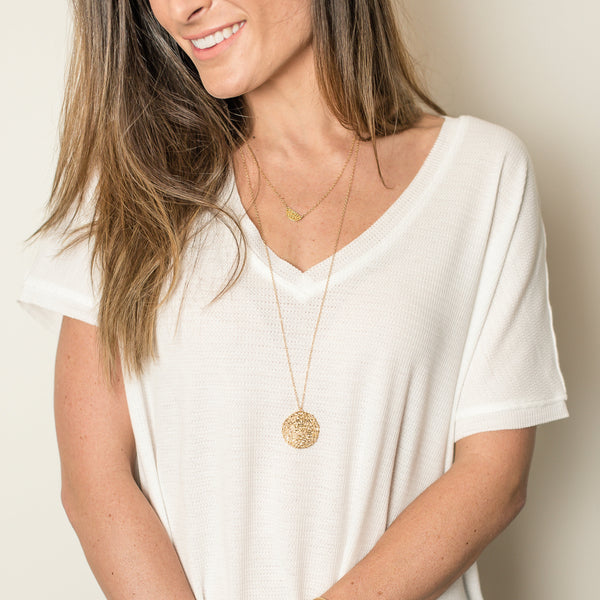 Woman wearing gold necklaces