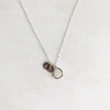 Silver necklace with embossed charms and stone
