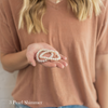 Woman holding two companion bracelets