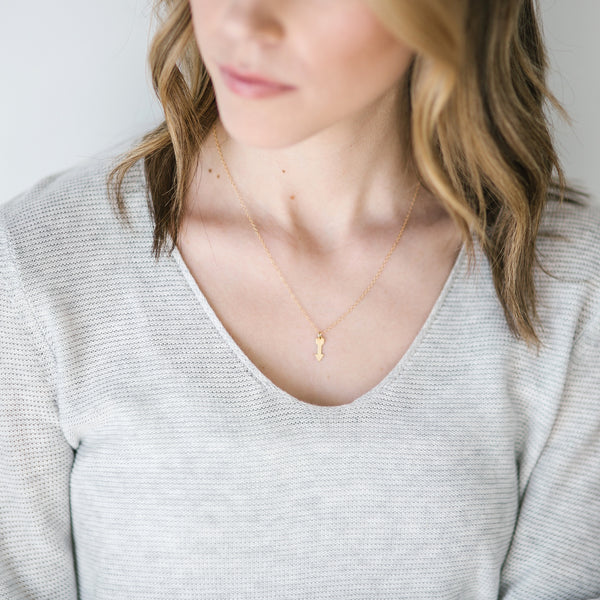 Woman wearing Quiver gold arrow necklace