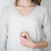 woman wearing Brass gold eclipsed locket necklace