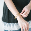 Woman wearing gold bracelets