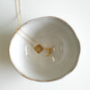 gold necklace square pendant with words come see engraved with gold small hoop earrings