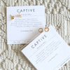 two pairs of captive earrings and verse cards