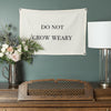 Do Not Grow Weary Endurance flag hanging on wall