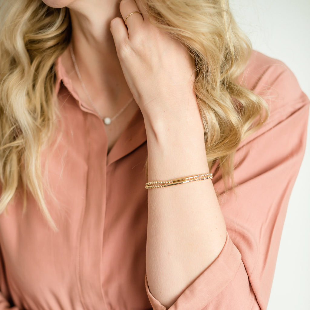 Woman wearing Believe bracelet and necklace