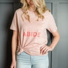 Woman wearing pink abide t shirt