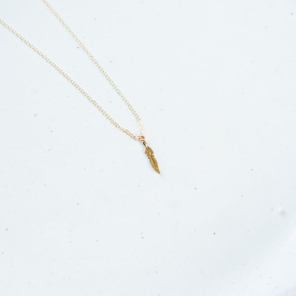 Plume gold feather necklace