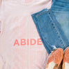 pink abide t shirt and jeans