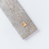 gold necklace square pendant with words come see engraved