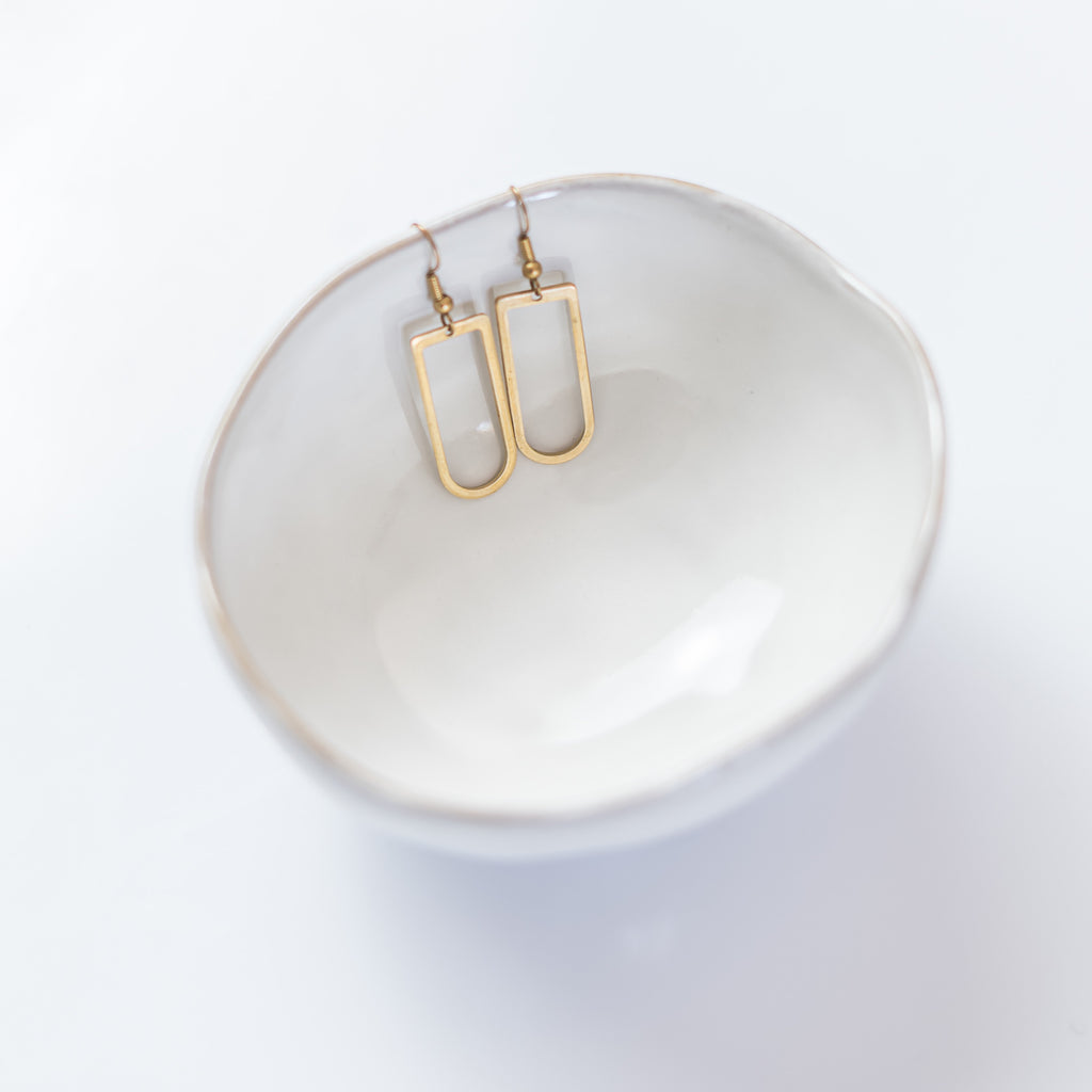 Brass U-shaped Nearness earrings in ring dish