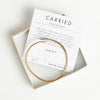 Gold carried bracelet and verse card