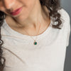 Woman wearing No. 139 necklace with glass stone