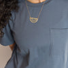 Woman wearing gold breastplate of righteousness necklace