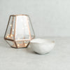 Ceramic ring dish next to glass decoration