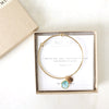 Gold bracelet with charm and gemstone